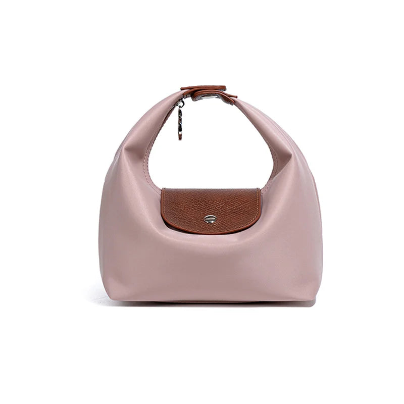A light pink waterproof nylon crossbody bag with dual brown leather straps.