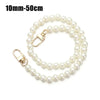 A delicate strand of white pearls used as a strap for a handbag or purse.