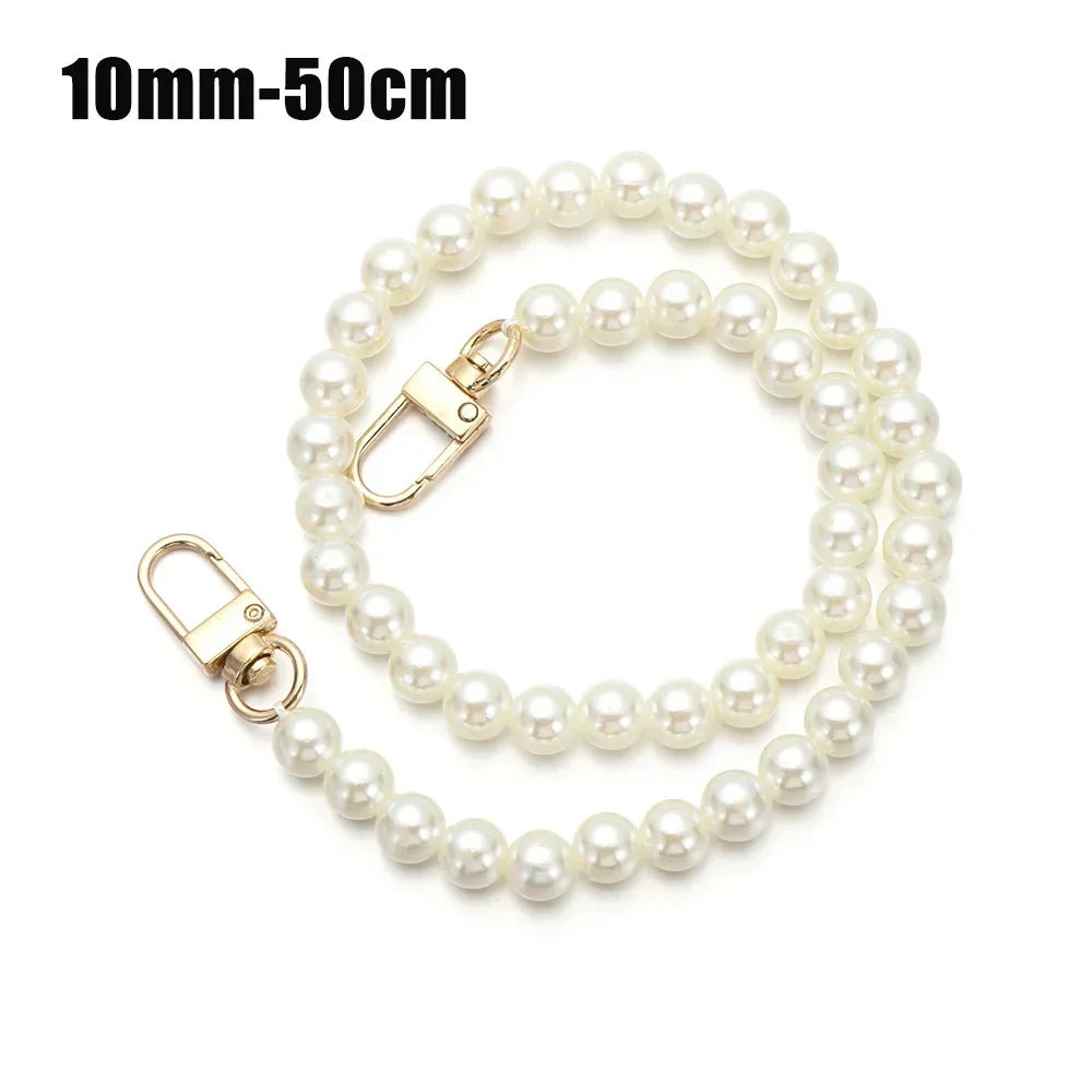 A delicate strand of white pearls used as a strap for a handbag or purse.