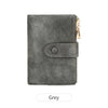 A grey minimalist triple layer card holder wallet with a leather texture and gold-toned zipper.