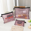 A collection of portable mesh cosmetic storage pouches in pink and black patterns displayed on a white surface.