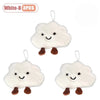 Three white cloud-shaped plush keychains or brooch pins