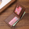 A brown leather bifold wallet with several cards and cash is shown on a wooden surface.