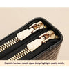 A close-up of a black PU leather wallet featuring gold-toned hardware and a double zipper design.