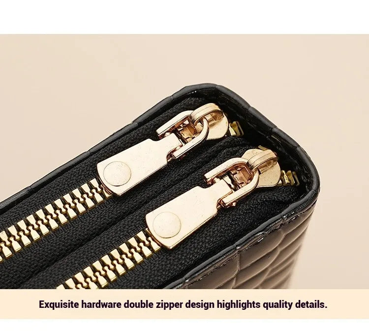 A close-up of a black PU leather wallet featuring gold-toned hardware and a double zipper design.