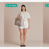 Three women model a lightweight quilted crossbody tote bag in gray and white tones.