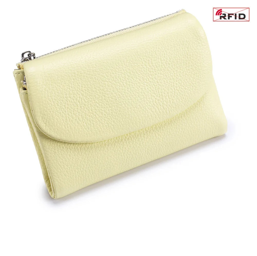 A pale yellow genuine leather mini card holder wallet with a silver zipper visible.