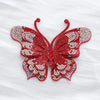 A vibrant red butterfly made of sparkling rhinestones and fabric applique.