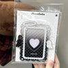 A clear plastic holder containing a black acrylic photocard featuring a heart design and decorative borders.
