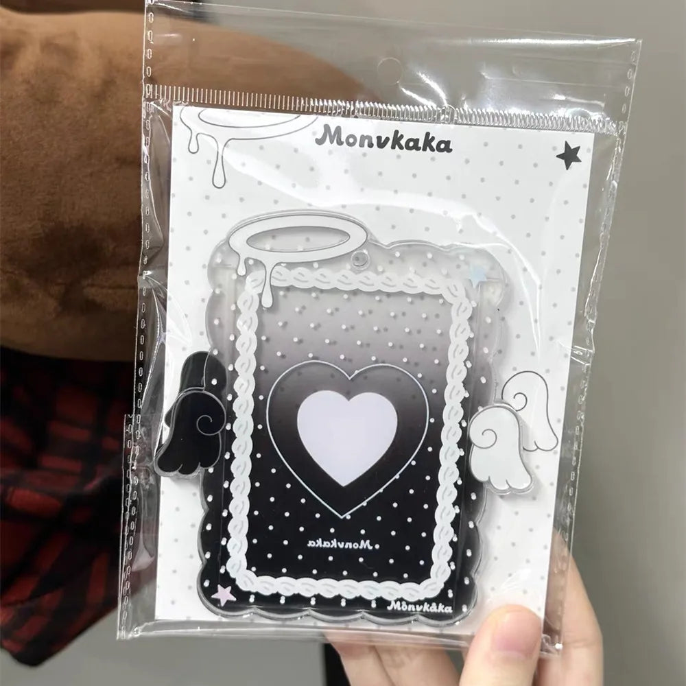 A clear plastic holder containing a black acrylic photocard featuring a heart design and decorative borders.