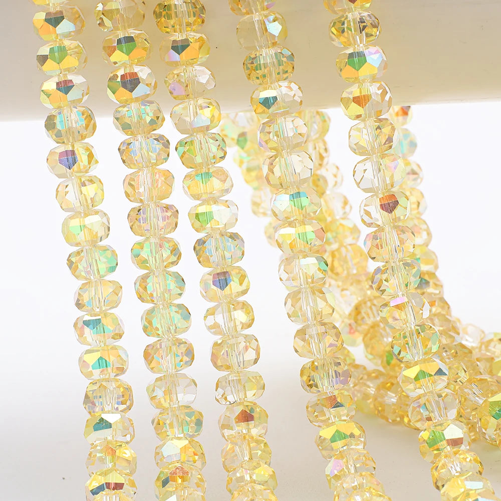 Strands of yellow and clear AB faceted crystal glass beads in a wheel shape for jewelry making