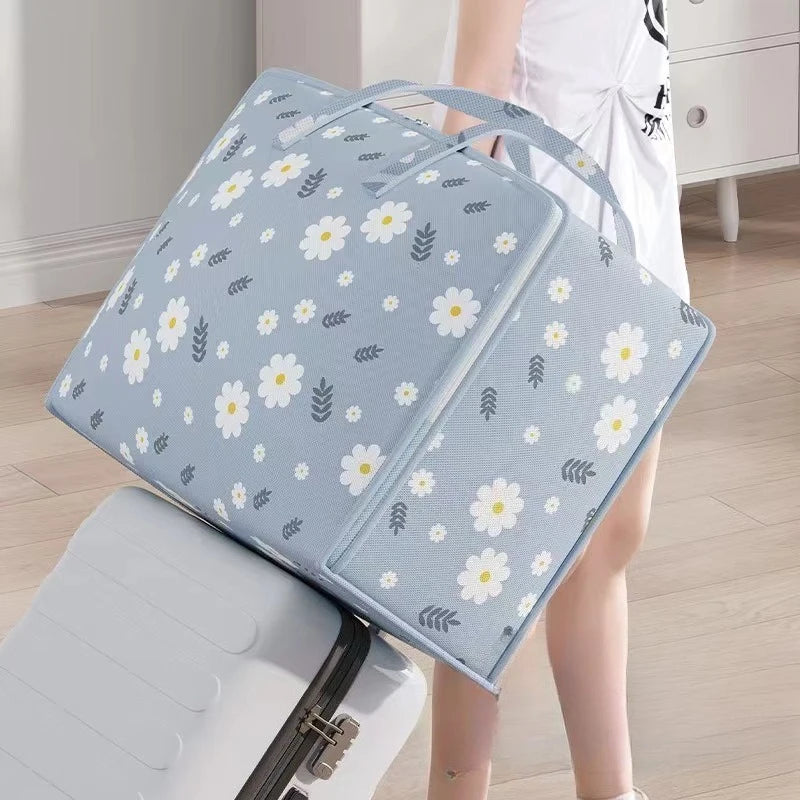 Light blue blanket storage bags with a white floral pattern are shown next to a white storage bin.