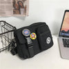 A black quick-dry canvas shoulder bag with a leather strap and a circular badge featuring the number 66.