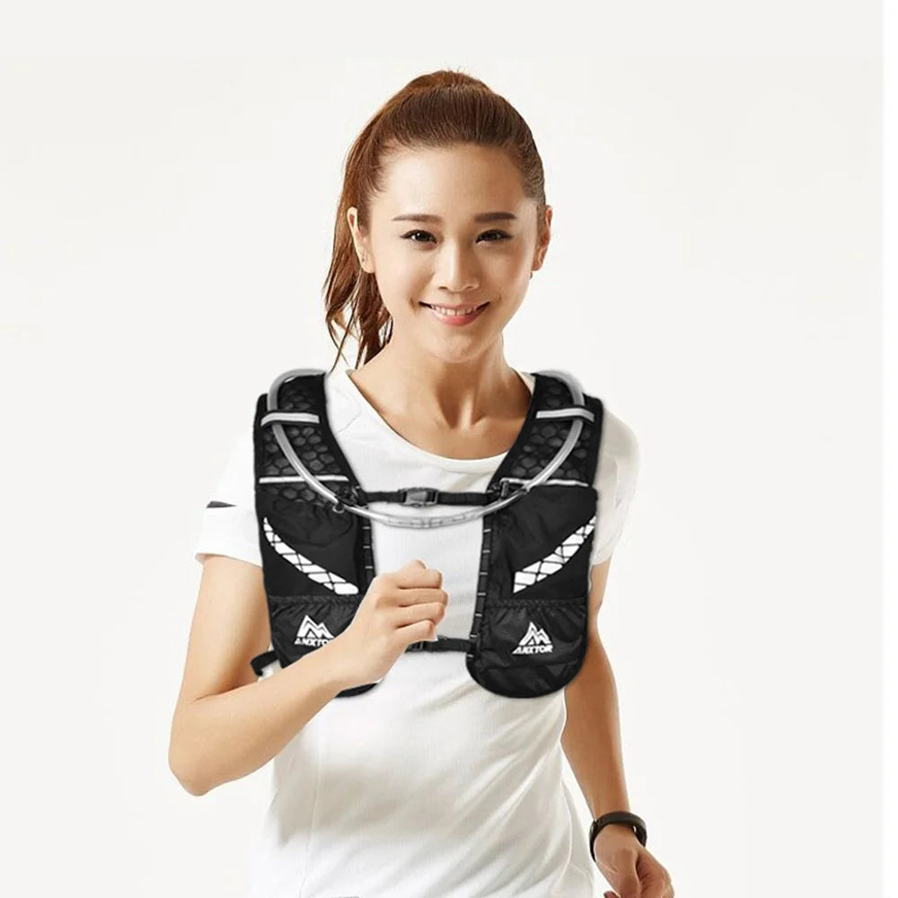 A woman wearing an black hydration vest for trail running and fitness.