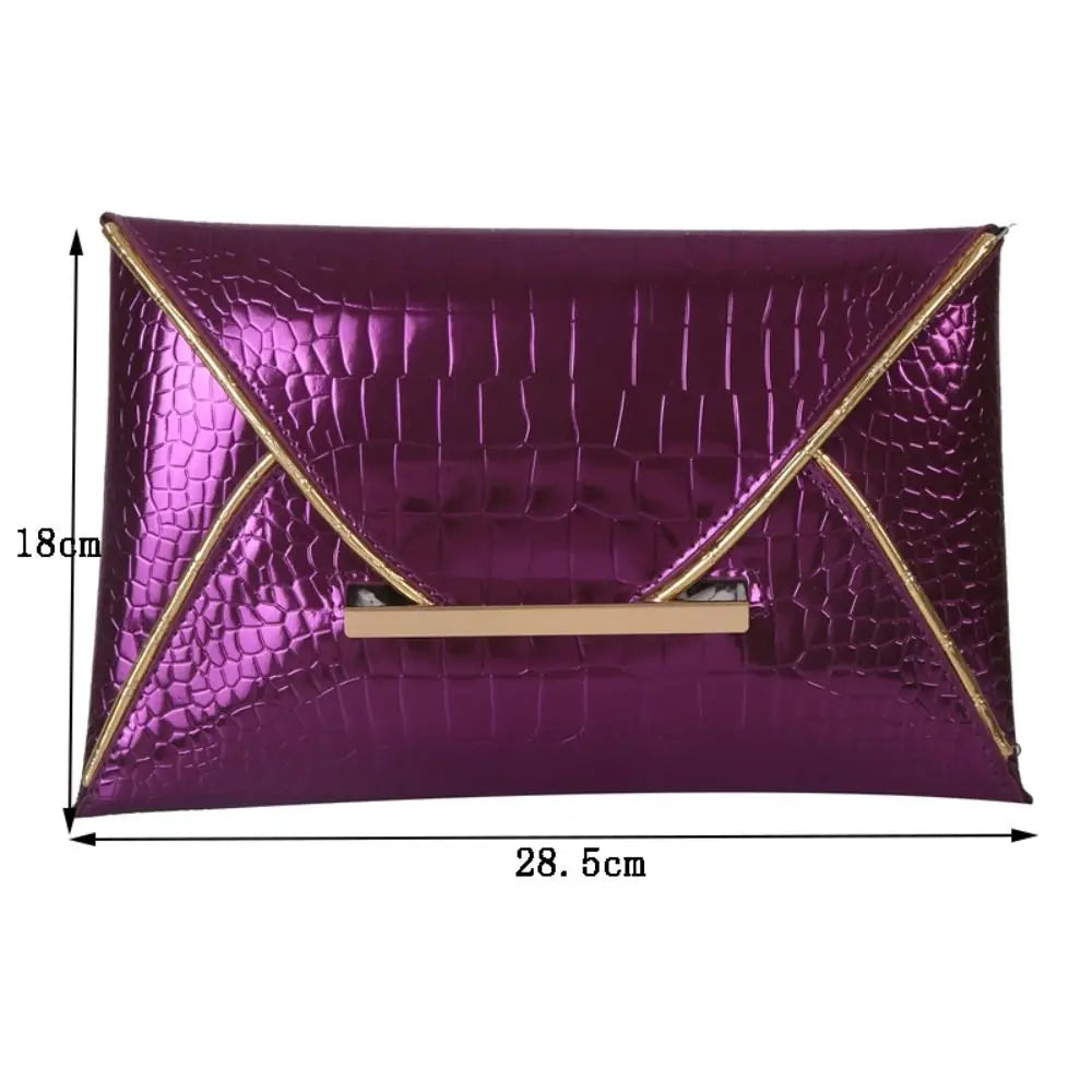 A rectangular purple crocodile pattern coin purse clutch with gold trim.