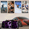 A purple butterfly print travel duffel bag is placed on the hood of a red sports car.