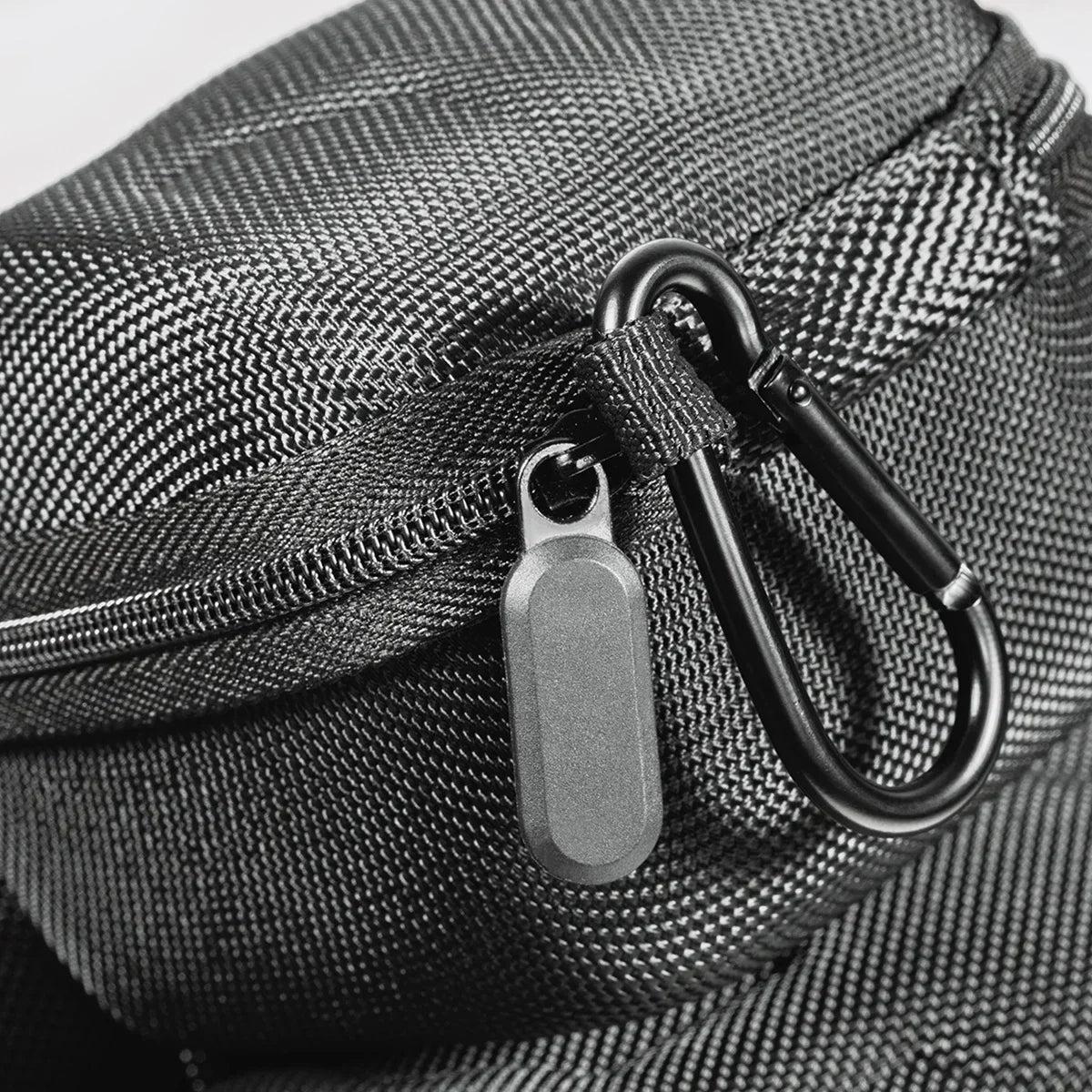 A close-up of a black woven fabric watch organizer travel case with a silver metal clasp.