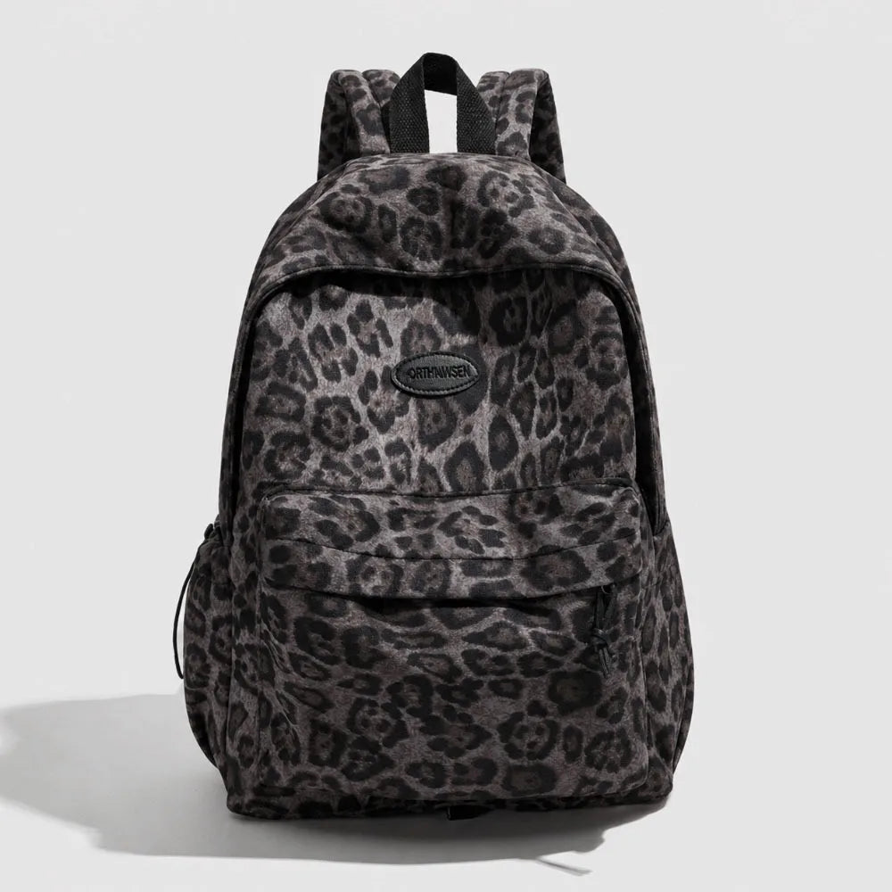 A dark gray leopard print laptop backpack with padded straps.