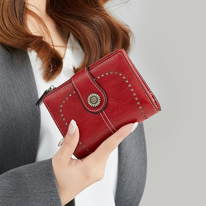 A close-up of a red leather RFID anti-theft multi-card wallet being held by a woman.