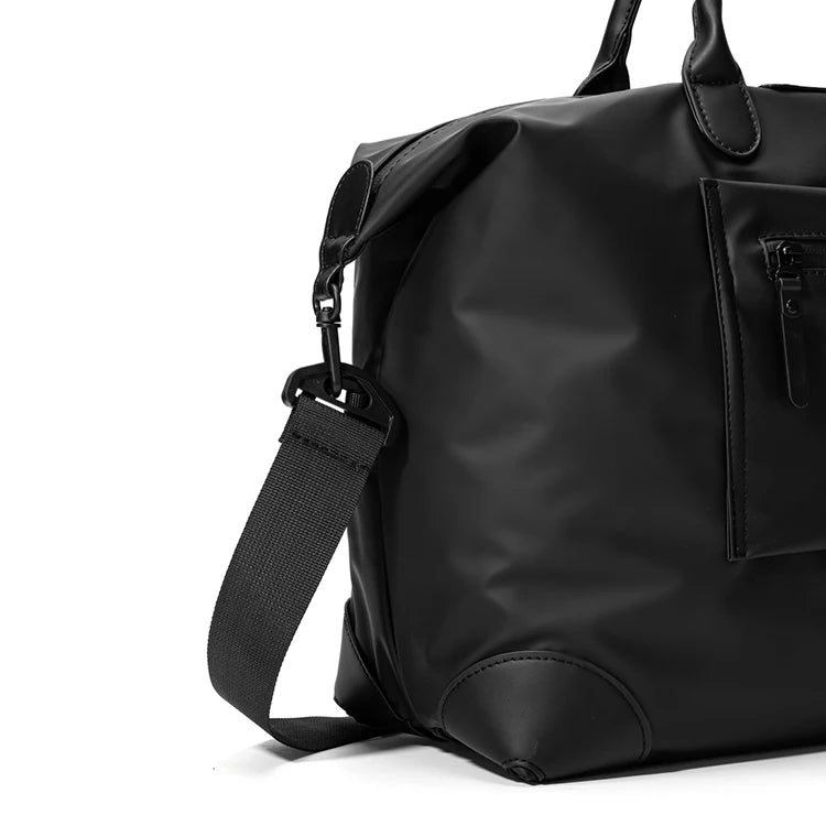 A black durable nylon travel duffle bag with a top handle and shoulder strap.