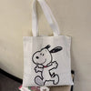 White canvas shoulder bag featuring a black line drawing of Snoopy