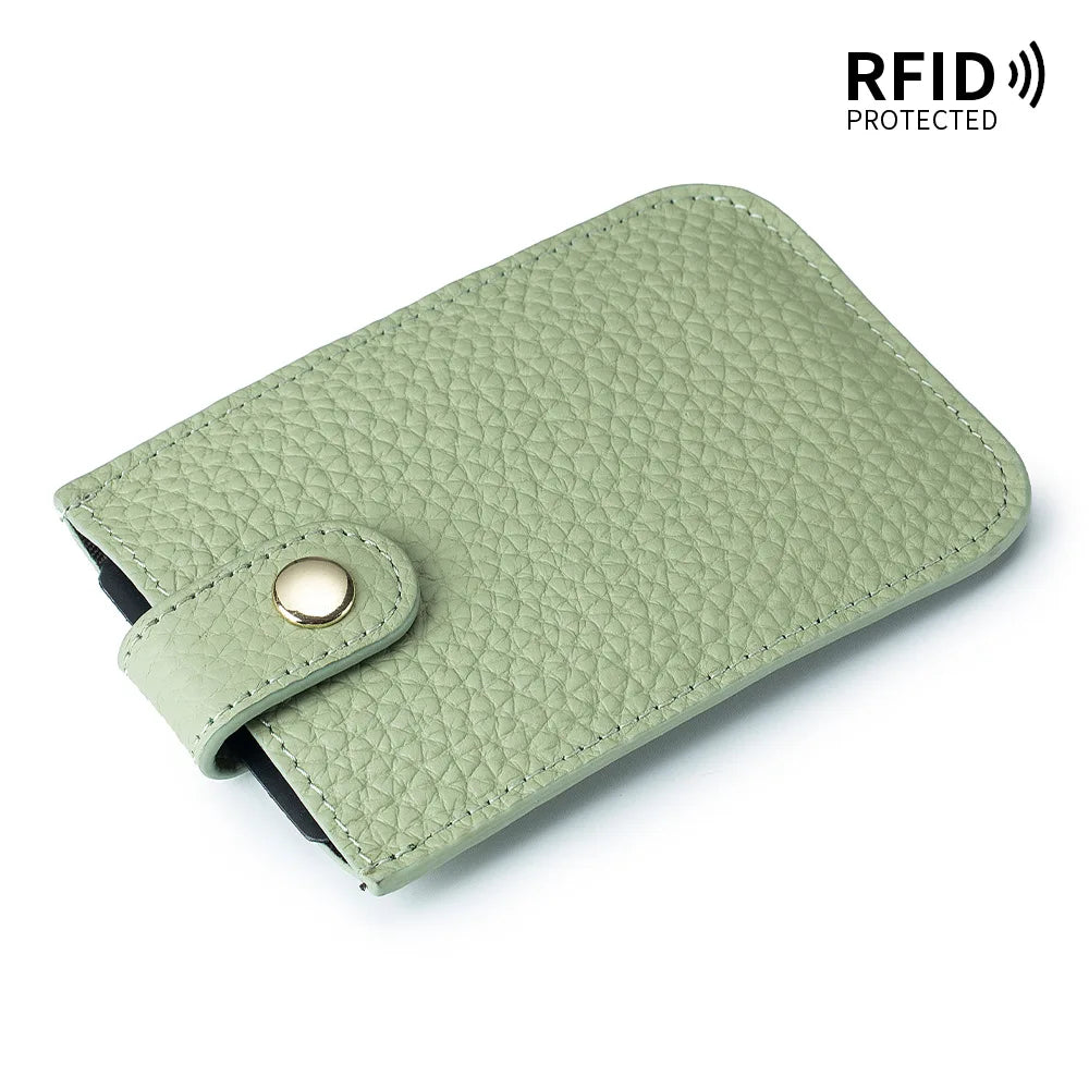 A light green genuine leather slim card holder with a stitched texture and a black lining.