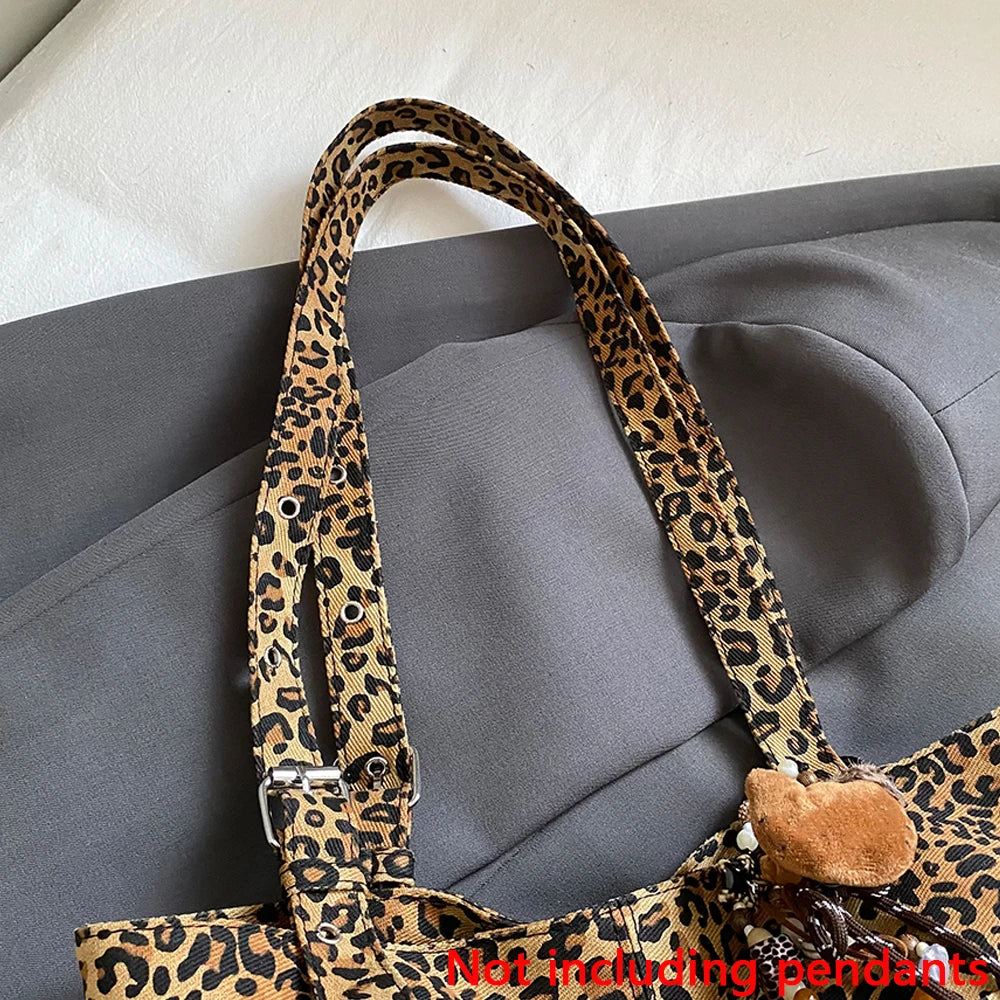 A close-up of a brown leopard print casual tote bag strap against a gray fabric background.