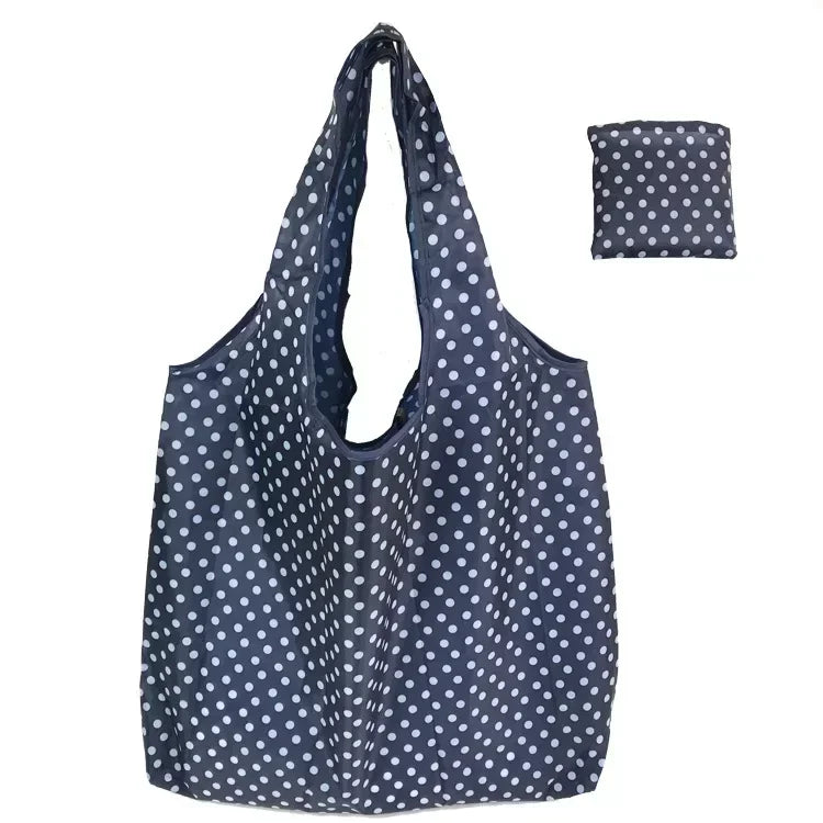 Navy reusable fashion shopping tote bag with white polka dots shown in a vertical layout.