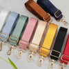 A collection of colorful adjustable nylon shoulder straps in various shades including blue, green, pink, beige, yellow, and b