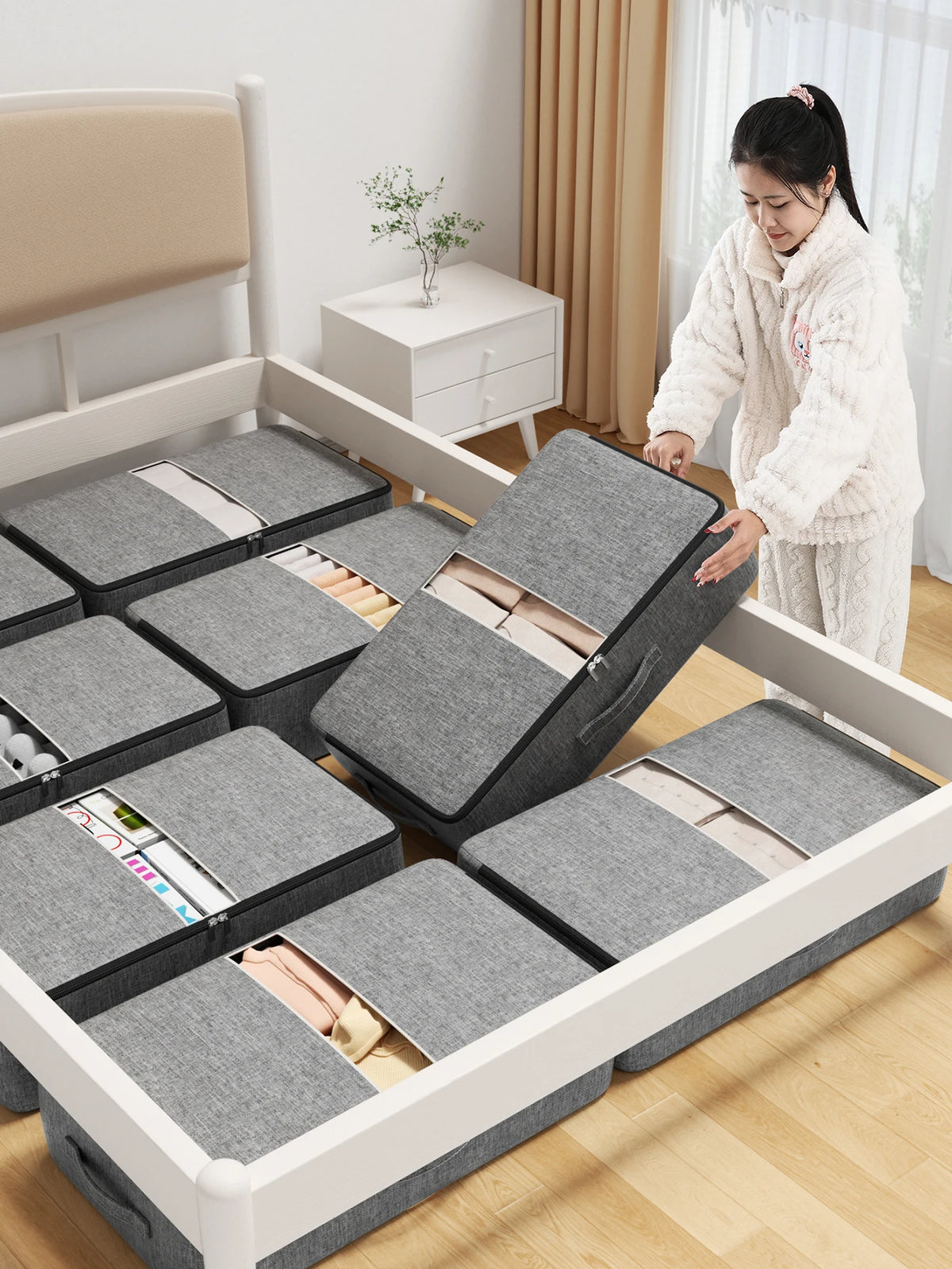 A white underbed storage bag with reinforced handles is shown open, revealing neatly folded clothing inside.