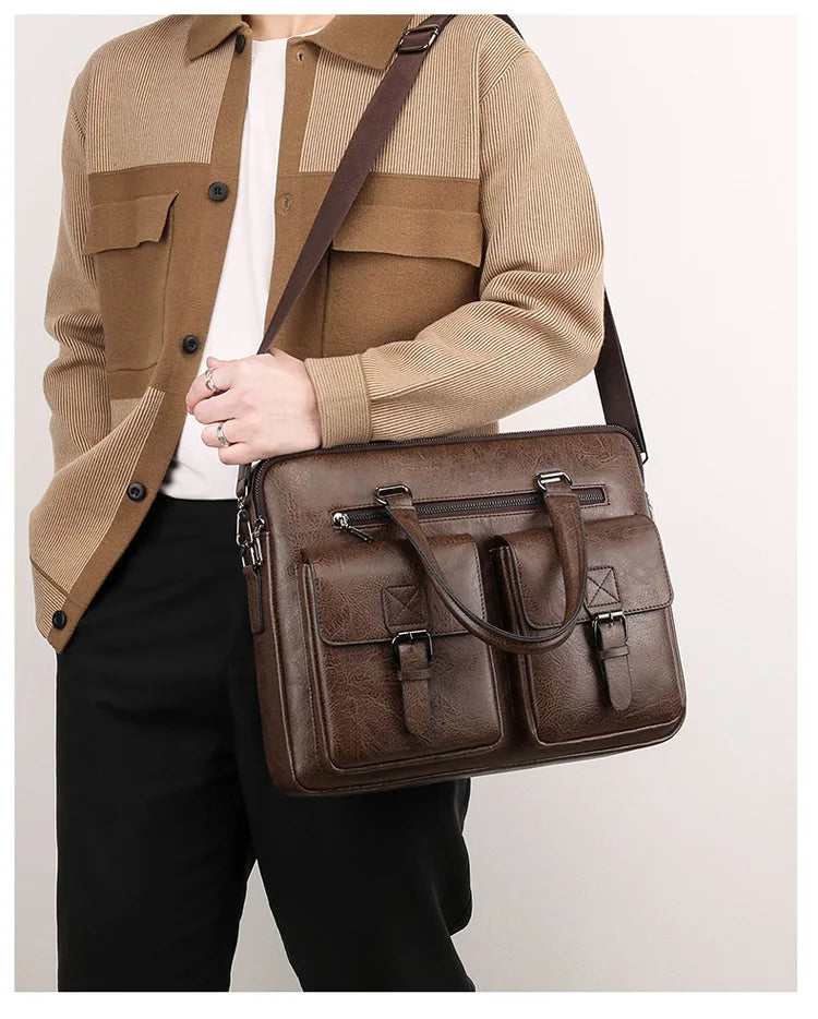 A man wearing a beige utility jacket and black pants carrying a brown PU leather business briefcase bag.