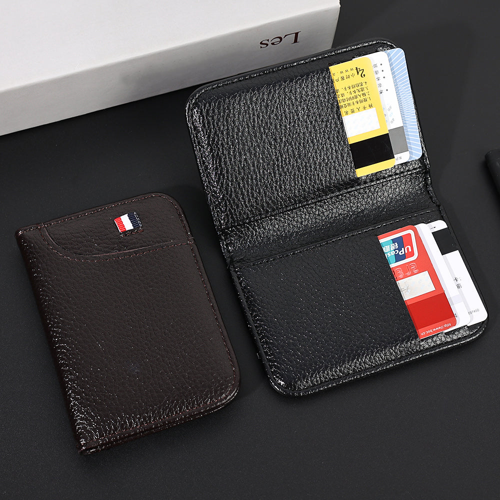 A black slim PU leather credit card wallet with multiple cards and a matching leather sleeve displayed on a dark surface.