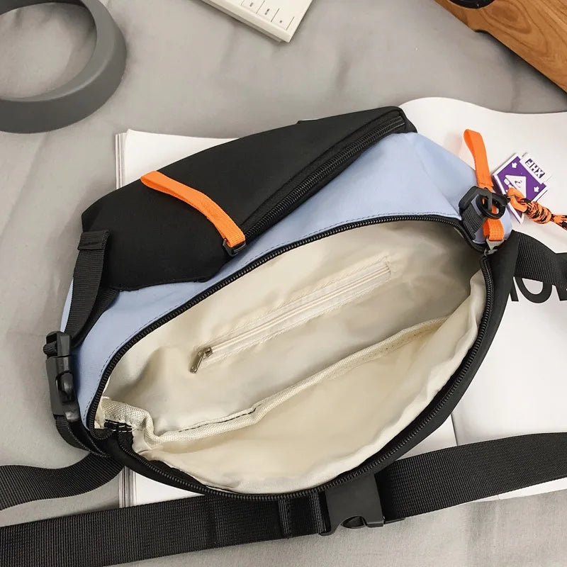 A black and light blue nylon chest rig bag is shown open, displaying its interior lining and strap.