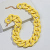 A yellow matte acrylic chain necklace with a gold-tone clasp displayed on a white background.