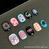 A set of colorful, cartoon-themed press-on nails featuring various designs like lightning bolts and hearts on a gray surface.