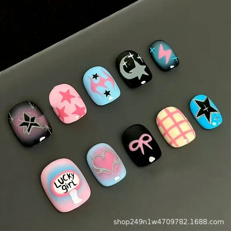 A set of colorful, cartoon-themed press-on nails featuring various designs like lightning bolts and hearts on a gray surface.