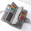 A gray leather zipper wallet with multiple card slots and a mesh pocket is shown on a white surface.
