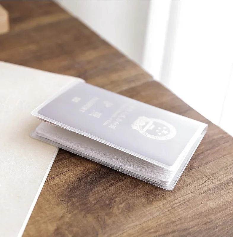 A triple pack of frosted clear card sleeves for ID and credit cards resting on a wooden surface.