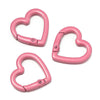 Two pink heart-shaped metal spring clasps are shown against a white background.