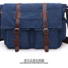 Sapphire blue canvas messenger bag with brown leather straps shown from the front.
