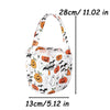 A white non-woven tote bag featuring a pattern of Halloween designs including pumpkins, ghosts, bats, and skulls.