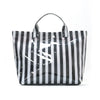A black and white striped tote bag with handles shown against a white background.