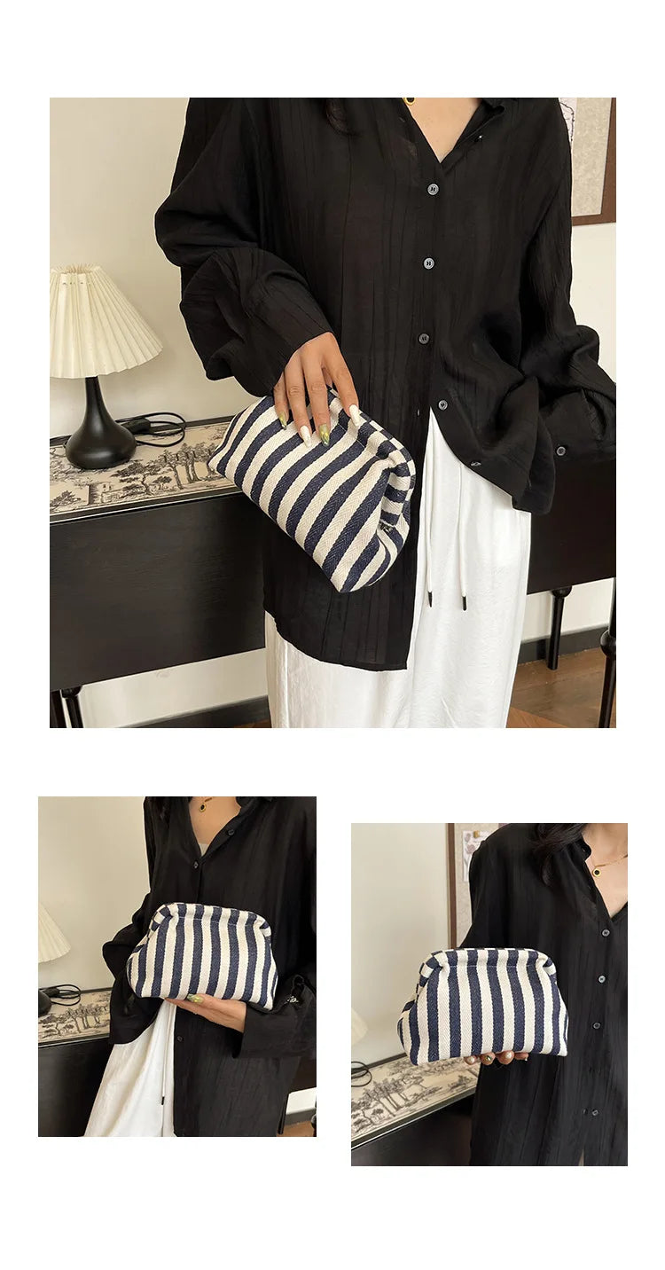 A woman holds a black shirt and white pants, displaying a striped black and white crochet handbag.