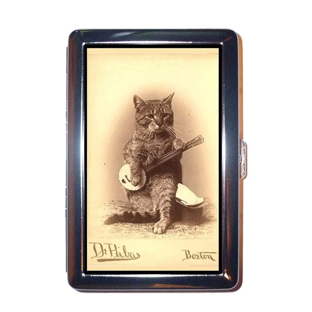 A vintage metal card holder displaying an illustration of a cat playing a guitar.