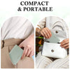 A close-up of a light mint green slim bi-fold wallet being held by a person, emphasizing its compact and portable design.