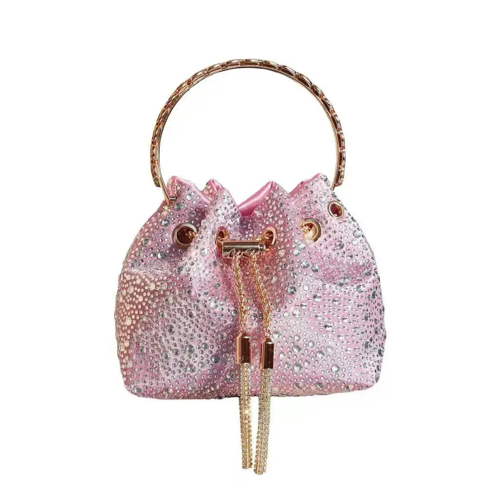 A pink crystal-embellished evening clutch with a gold chain strap.
