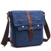 A dark blue canvas messenger bag for men with brown leather straps and buckles.