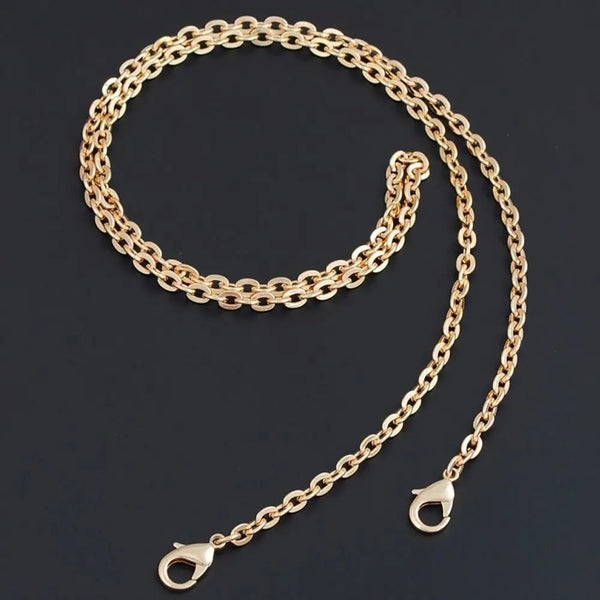A gold-colored adjustable metal chain strap for a crossbody bag, laid out against a dark background.