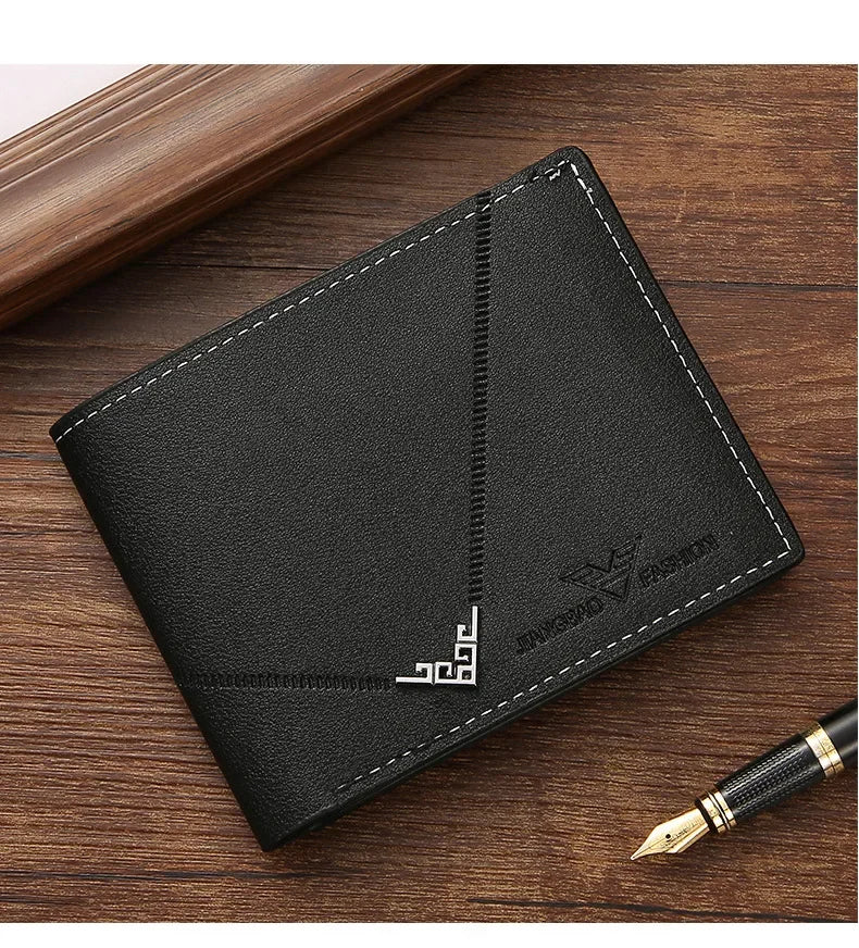 A black men's slim leather bi-fold wallet resting on a wooden surface.