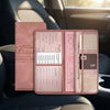 A pink PU leather car document organizer with clear pockets resting on a dark car seat.
